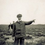 Wilbur Wright pointing to his left, in France