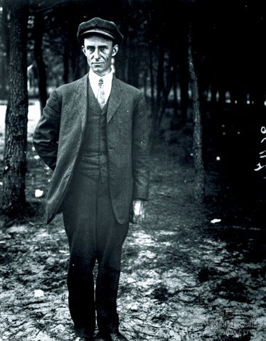 Wilbur Wright, standing, full-length, facing the camera.