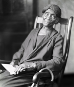 portrait of Matilda Dunbar in rocking chair holding a book