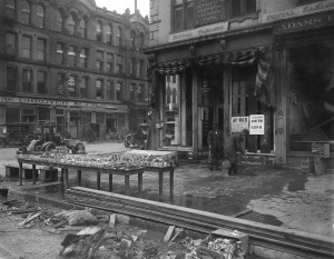 Cleanup and flood merchandise; note the curfew sign and NCR notices at right. (ms128_3-4-4)