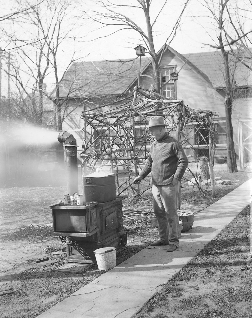 Edward Neukom cooking on his stove in the yard, April 6, 1913. Photo by Everett Neukom (ms128_3-1-11).