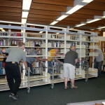 A group effort moving some shelves.