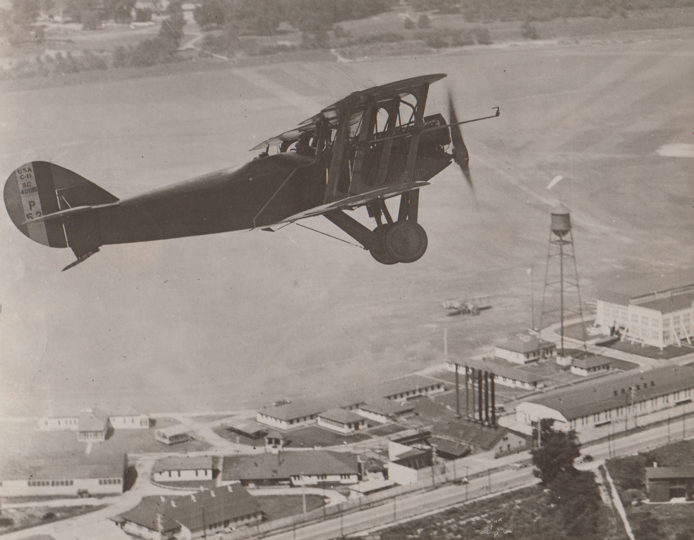 Airplane flying over McCook Field, undated