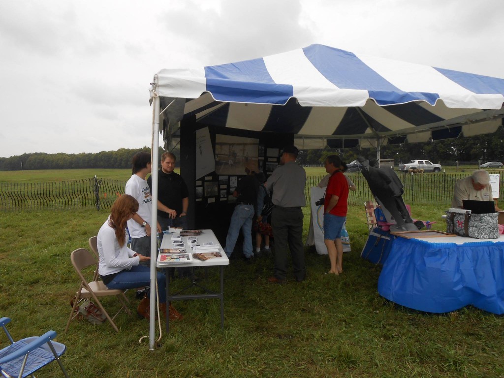 Public History students staffing our table at the Great Wright Brothers Aero Carnival while visitors check out our exhibit, Sept. 6, 2014