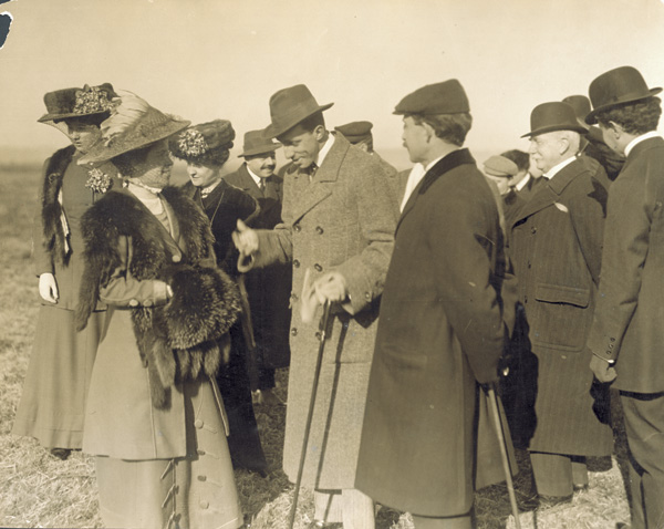 Katharine Wright speaks to Alfonso XIII, King of Spain, as Orville Wright, Mrs. Hart O. Berg, and others stand nearby, 1909. (photo ms1_18_1_17)