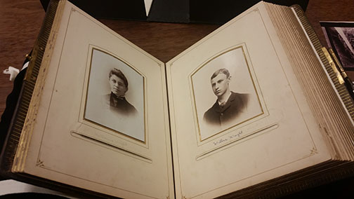 Wright Family Album open to page of Katharine and Wilbur Wright as teenagers. Album structure and split window housings repaired.