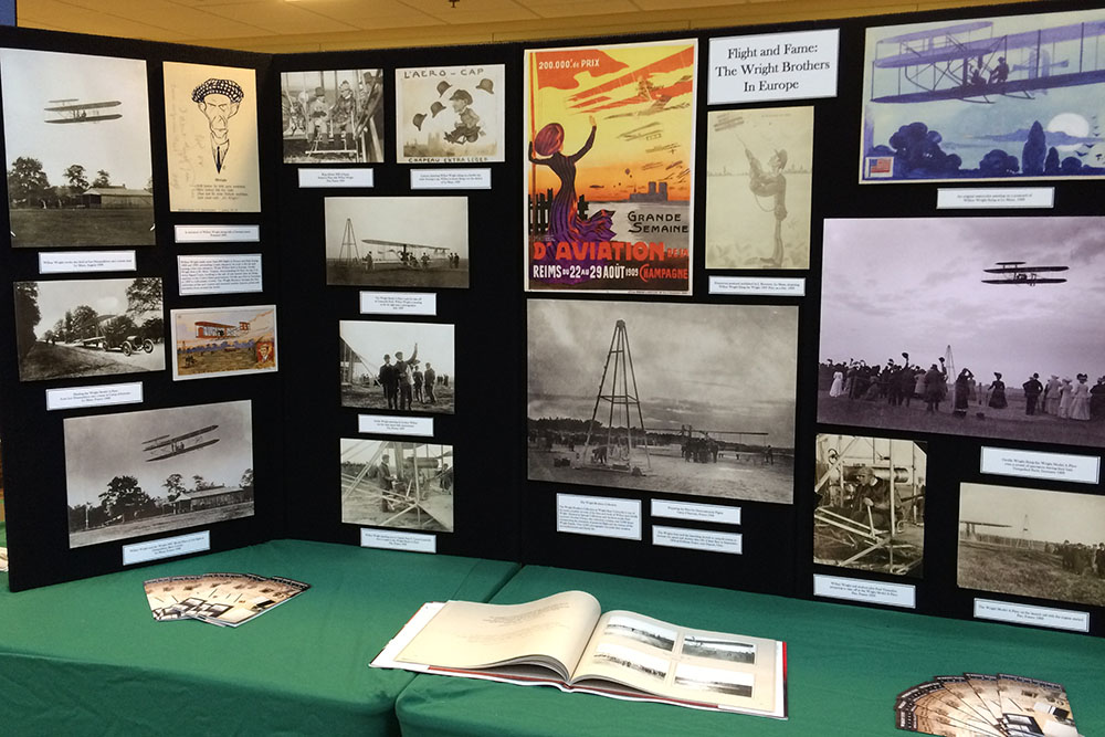 Wright Brothers Day display table with images related to the Wright Brothers and the history of flight